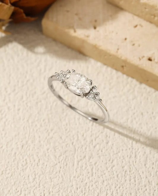 1 carat oval moissanite engagement ring in 925 sterling silver with zirconia side clusters
