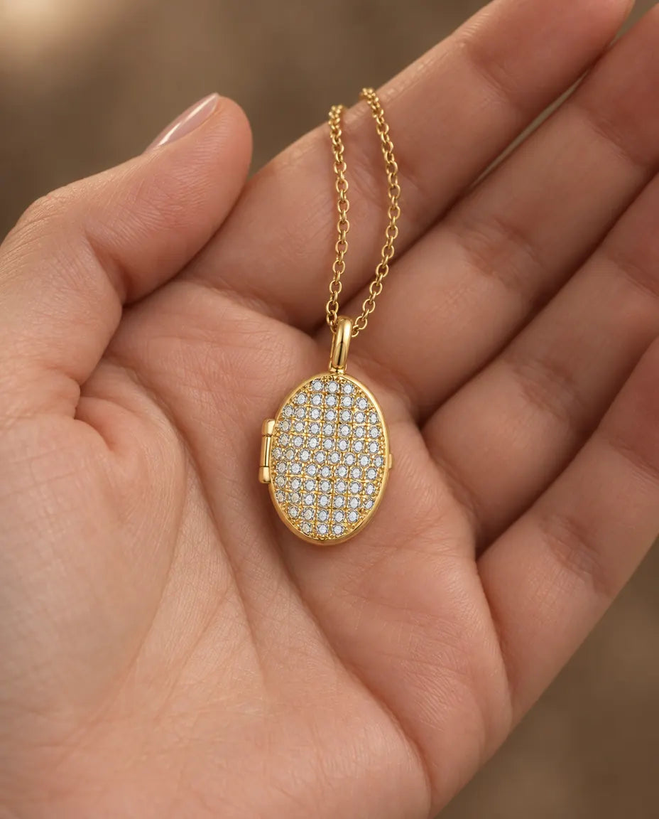 Personalised Pavé Crystal Oval Photo Locket Necklace That Holds 2 Pictures held in hand