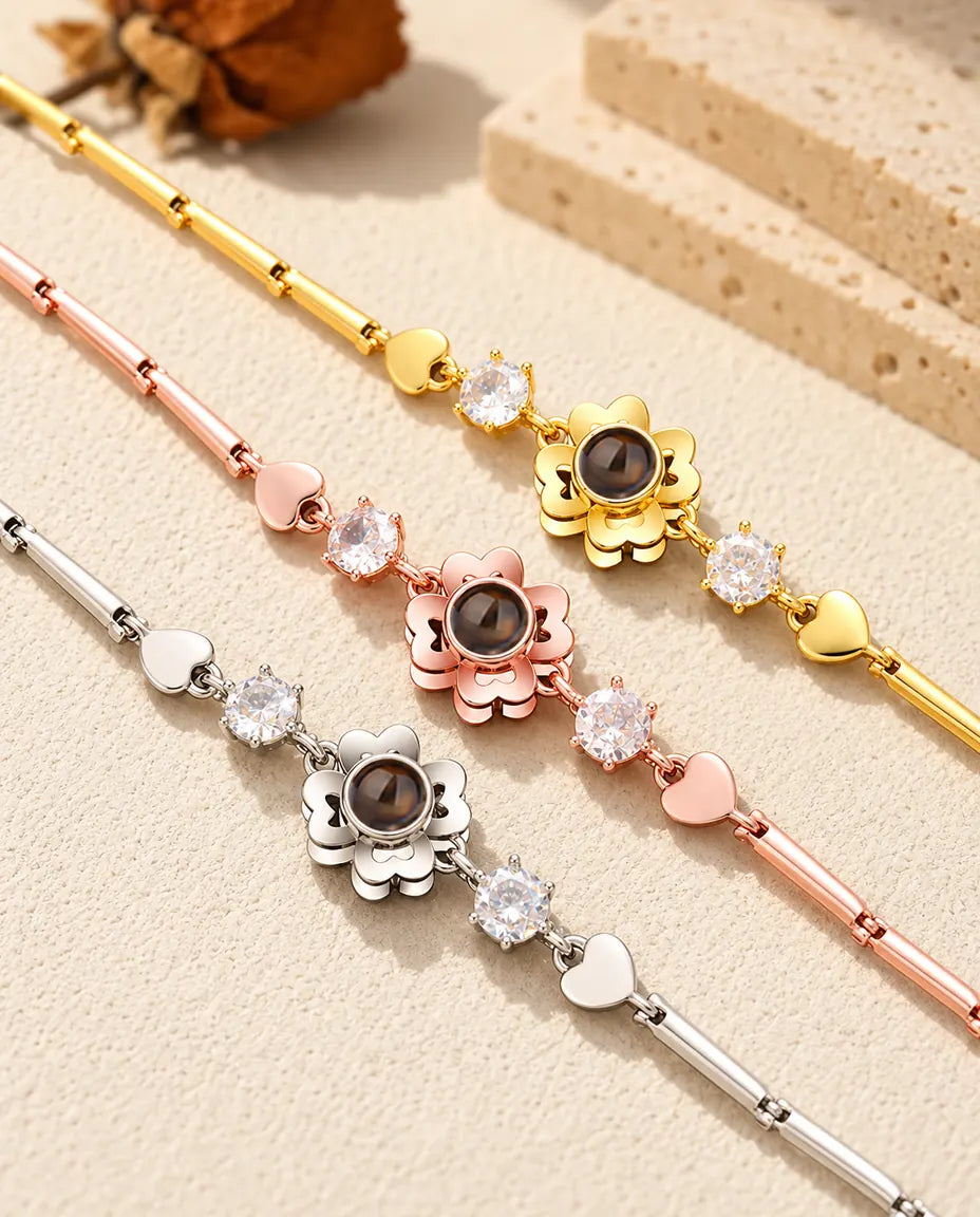 Close-up of three clover flower charms with heart petals in each colour