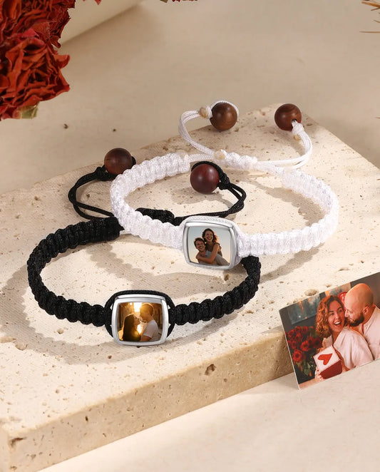 Matching black and white braided couple bracelets with square photo charms and photo card