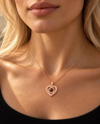 Woman in a black knit top wearing the rose gold tone double heart pave photo projection necklace