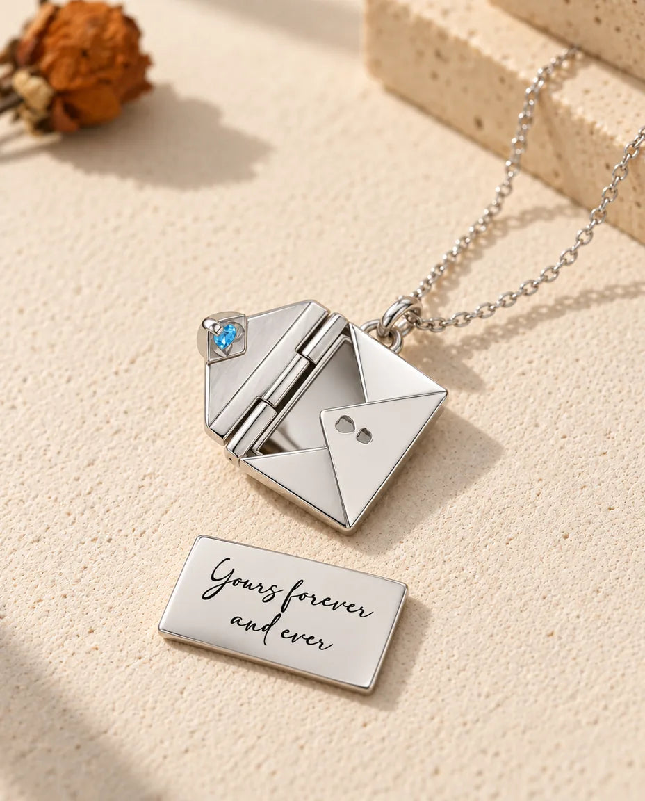 Engraved back of the silver envelope locket photo card reading “Yours forever and ever” in script