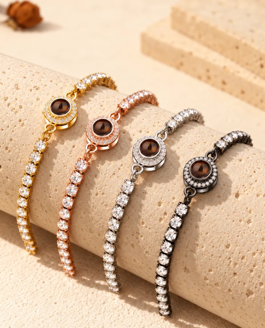 Four photo projection tennis bracelets draped over a travertine block in each colour