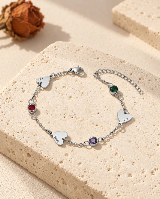 Personalised heart name bracelet with three engraved hearts and three birthstones in stainless steel