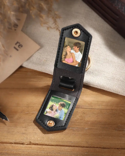 Black faux leather photo keyring open to show two custom pictures inside