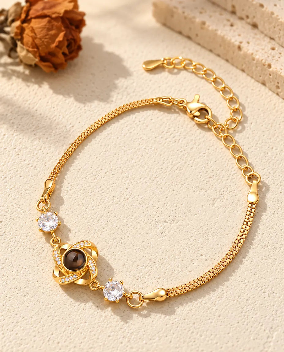 Gold tone love knot photo projection bracelet with lobster clasp and extender chain
