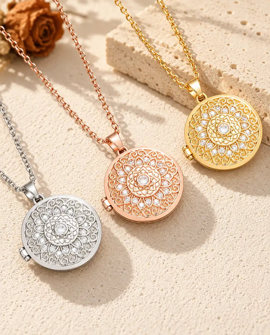 Mandala flower photo lockets in silver tone, rose gold tone and gold tone laid diagonally on cream plaster