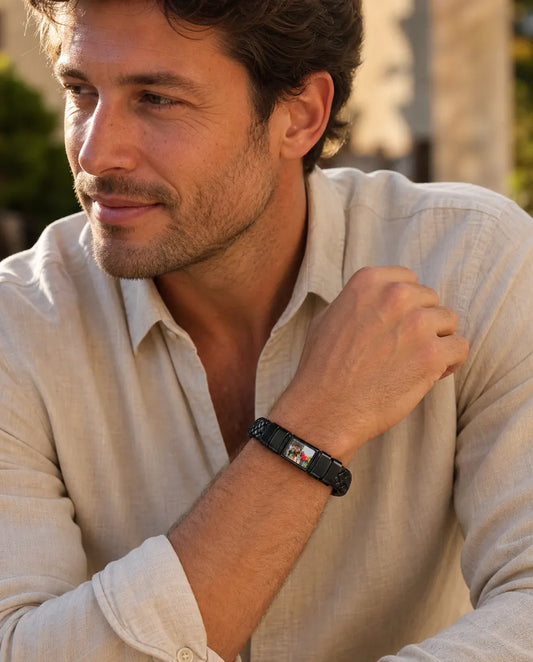 Man wearing black braided leather bracelet with photo bead outdoors