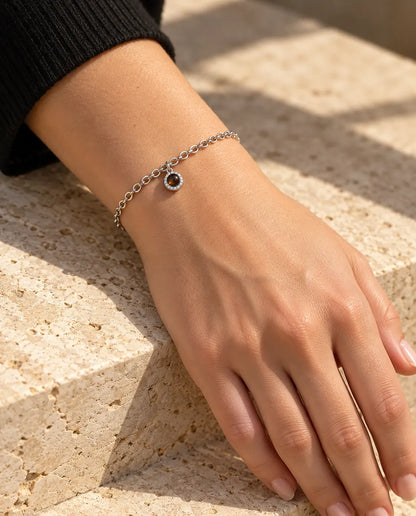 Woman wearing the silver tone pave circle photo projection bracelet on her wrist in warm sunlight