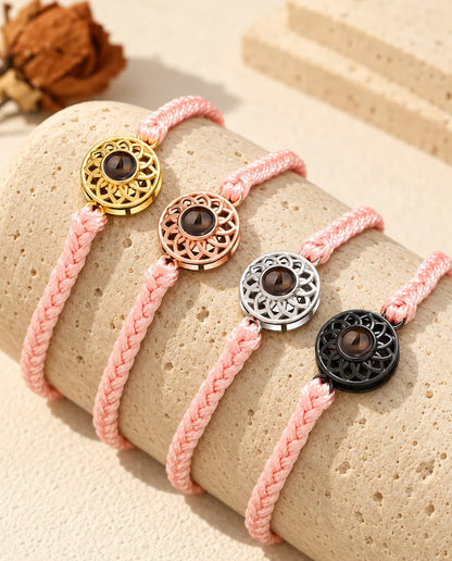 Pink thin braided cord projection bracelets with gold tone, rose gold tone, silver tone and black round charms