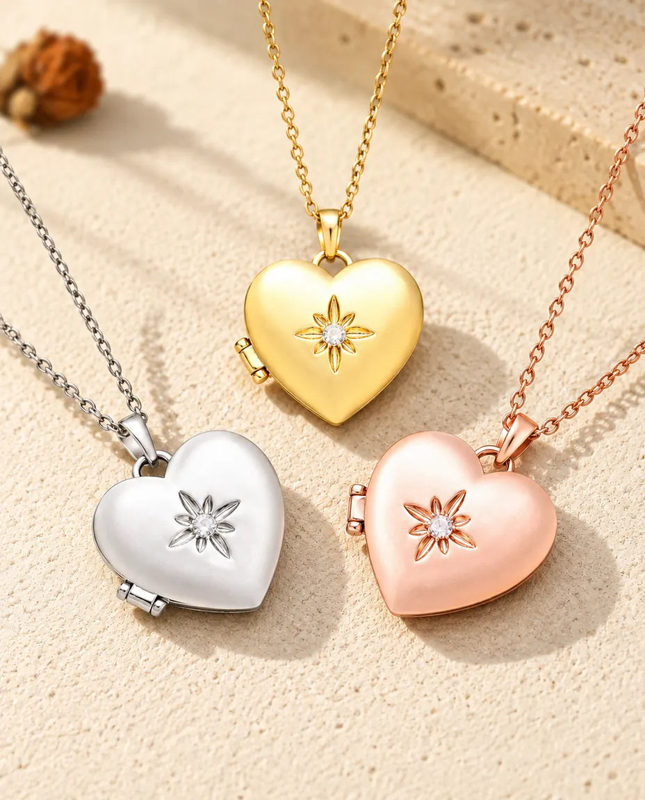 Three colours of the satin flower heart photo locket necklace arranged on plaster