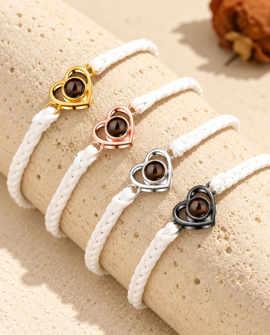 White braided cord open heart bracelets lined up in each charm colour