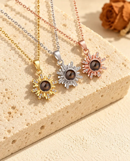 Gold tone, silver tone and rose gold tone sun pendants side by side