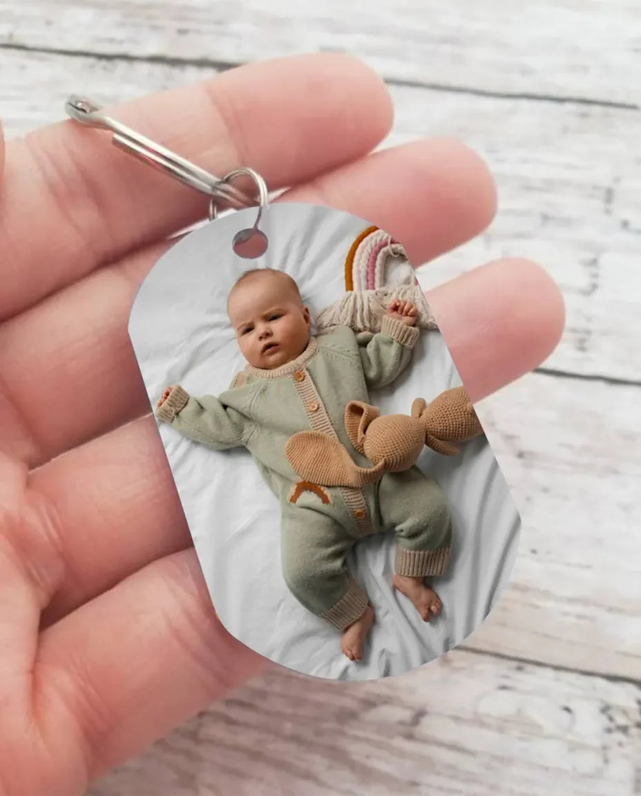 Hand holding the personalised baby photo keyring