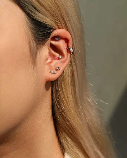 Silver Ball Trefoil Stud Earrings in 925 Sterling Silver - worn in the ear, close-up