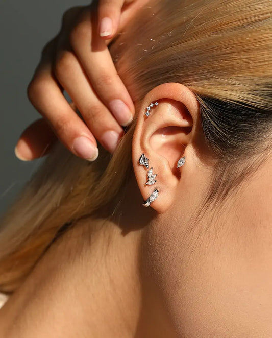 Seashell Stud Earrings in 925 Sterling Silver - worn on a model with her hand at the back of her head