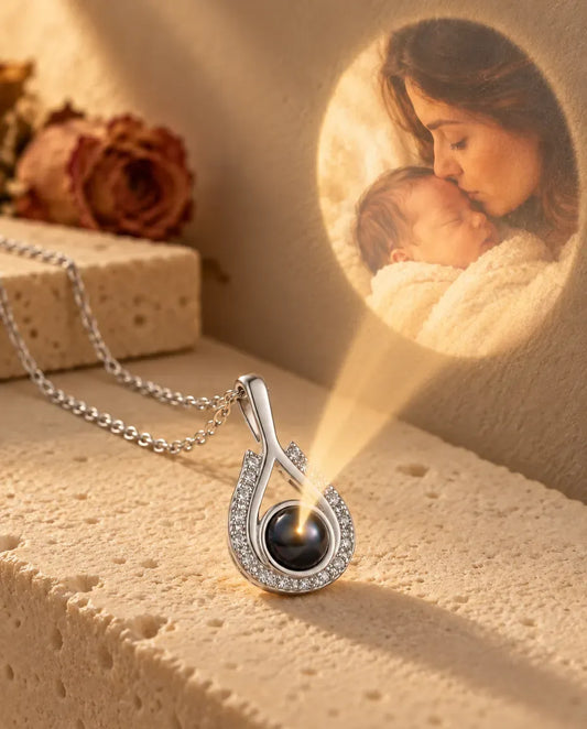Personalised Teardrop Photo Projection Necklace in Silver - projecting the hidden photo onto a wall