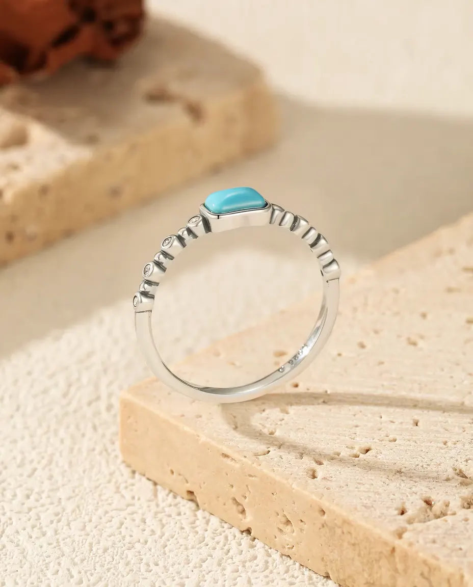 Turquoise cabochon ring on beaded bezel band in 925 sterling silver
