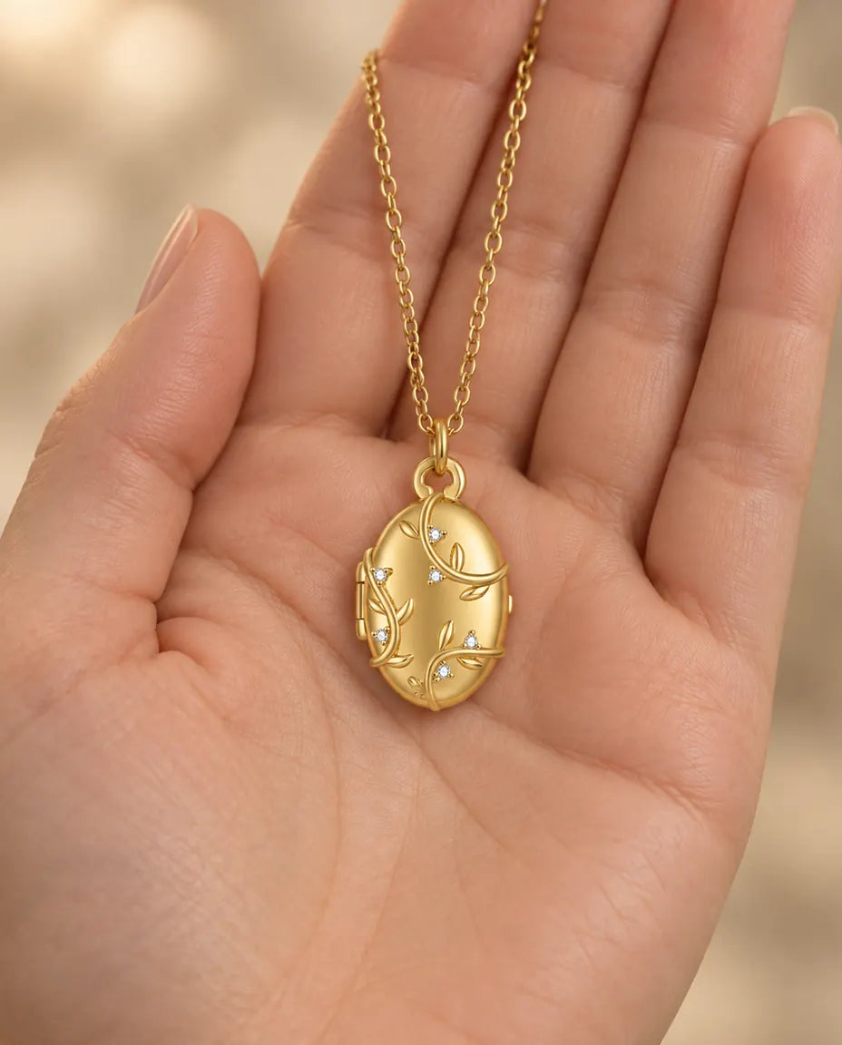 Personalised Vine & Crystal Oval Photo Locket Necklace That Holds 2 Pictures held in hand