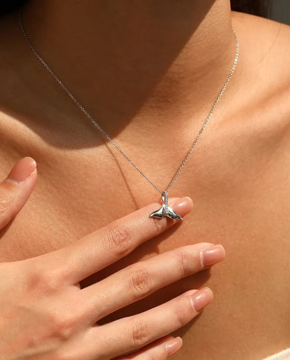 Whale tail pendant necklace in 925 sterling silver with a pave set bail