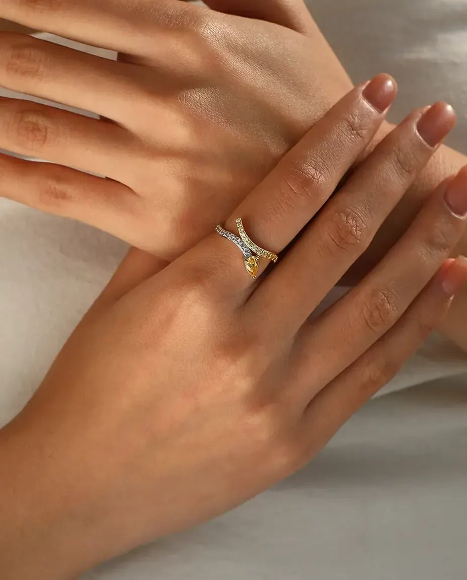 Yellow pear cut bypass ring in 925 sterling silver with two tone pave bands