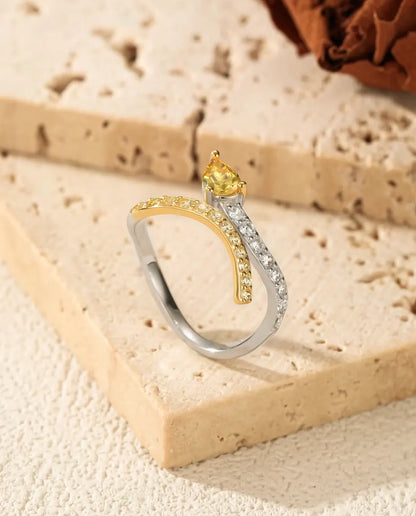 Yellow pear cut bypass ring in 925 sterling silver with two tone pave bands